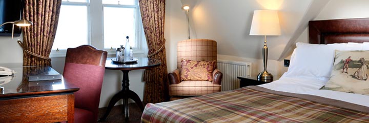 A feature double bedroom overlooking the St Andrews Old course at the Macdonald Rusacks Hotel
