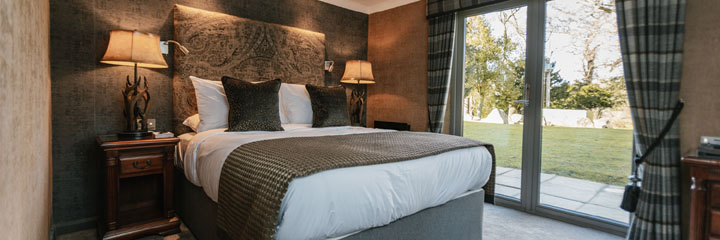One of the newly refurbished bedrooms at the 4 star Maryculter House Hotel in Aberdeenshire. This stylish room, combining traditional and contemporary, opens up to a terrace