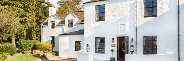 The white washed traditional exterior of the 4 star Maryculter House Hotel which is based around buildings dating back to 1227 and the Knights Templar.