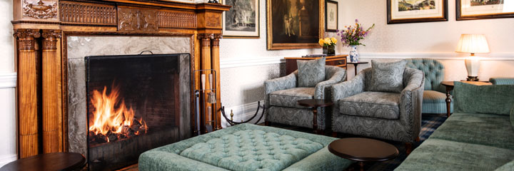 The Drawing Room at the Schloss Roxburghe Hotel in the Scottish Borders. The Drawing room is traditionally styled, reflecting the heritage of the building, and has a large open fire.