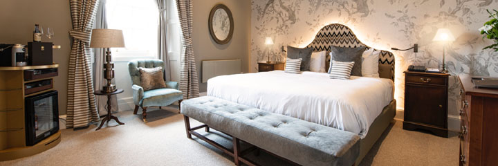A Superior double bedroom at the Schloss Roxburghe Hotel in the Scottish Borders, featuring a king size bed and a mix of traditional and contemporary styling.