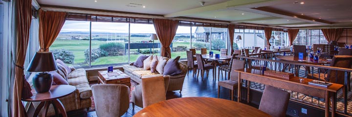 The dining room of the 4 star Royal Golf Hotel in Dornoch, overlooking the 1st tee of the Championship course of Royal Dornoch Golf Club, and the clubhouse.