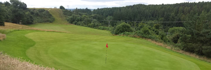 The 12th green of Alness Golf Club, looking back towards the raised tee