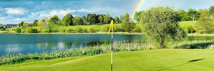 A view across Lochmaben golf course with a rainbow in the background