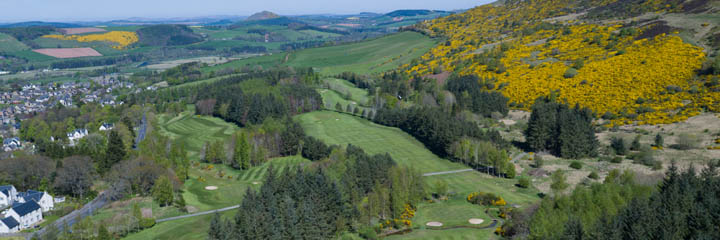 An aerial view of Melrose Golf Club, at the foot of the Eildon Hills, with the town of Melrose to the left of the course.