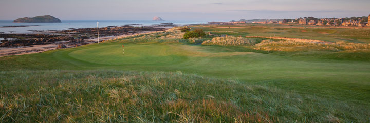 Looking to the green of the 14th hole - Perfection - of the North Berwick West Links. The tall white marker post behind the green is because the approach shot is blind over a ridge. The Bass Rock is i