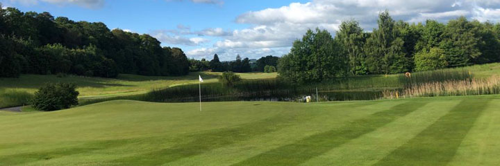 The green of the 4th hole at the Schloss Roxburghe golf course in the Scottish Borders, with water directly behind the green